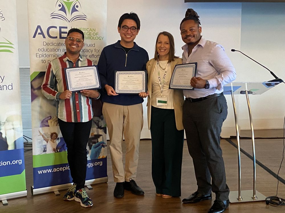 All four ACE Scholars pose for a picture with their plaques