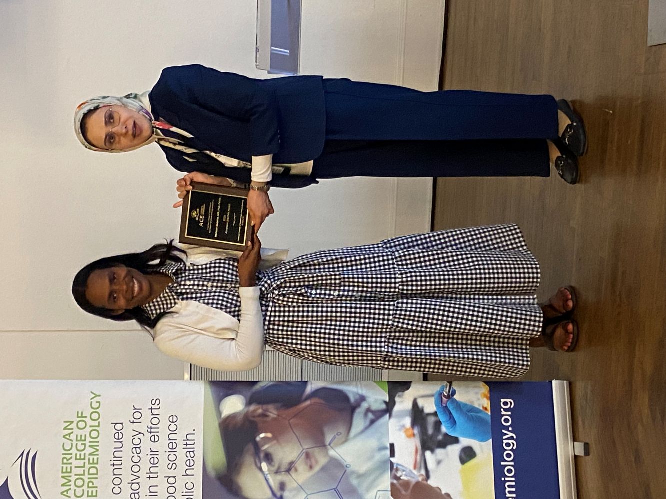 The Lilienfield Award recipient smiles as she receives her plaque